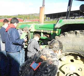 students around a green tractor at 28th annual Agriculture Skills Contest