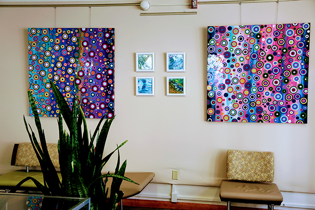 paintings hanging on the wall by Ithaca artist Ivy Stevens-Gupta