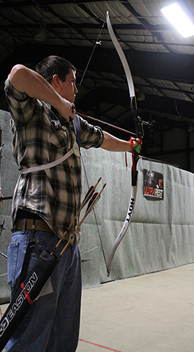 Ethan Frederick takes aim with his bow