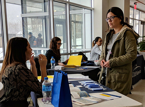 student speaking with an employer at career fair