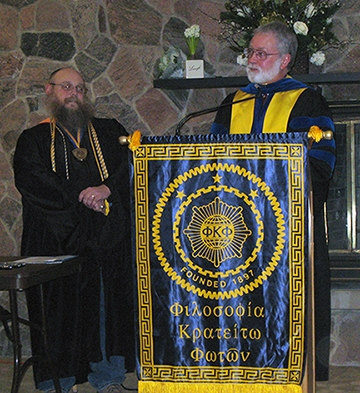 Mechanical and Electrical Engineering Technology Associate Professor Christopher Tomasi, left, is installed as president of the Alfred State chapter of the Phi Kappa Phi honor society Thursday by Dr. Rick Shale, professor of English at Youngstown State University.