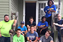 group of students in front of a house