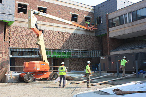 construction workers and equipment outside of MacKenzie Complex
