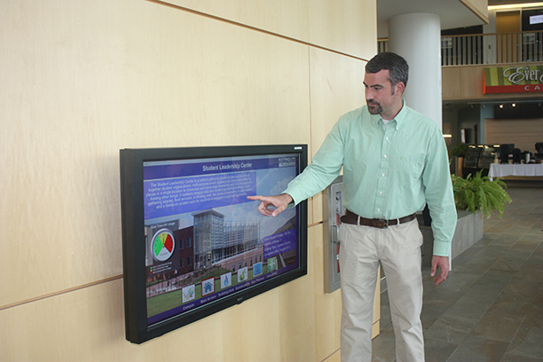 Mike Smith, manager in Technology Services, observes readings from the energy efficiency monitor