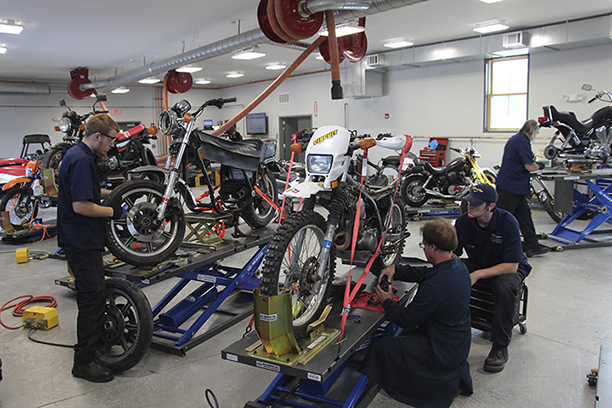 students working on motorcycles in the lab
