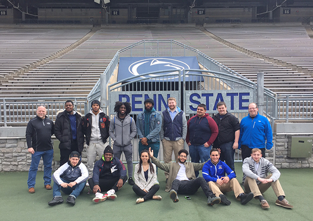 several students at Penn State’s Beaver Stadium 