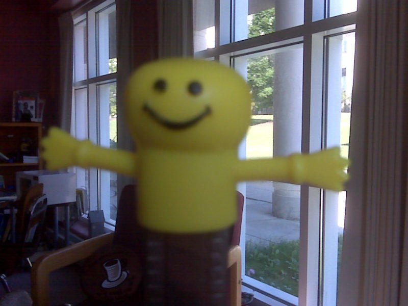yellow stick figure with smile and arms spread open